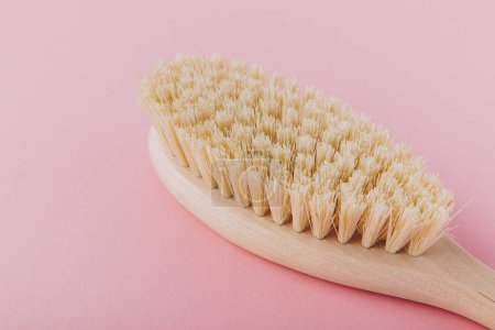Photo for Massage brush. Natural wooden brush for body massage on pink background. Eco-friendly lifestyle concept and zero waste - Royalty Free Image