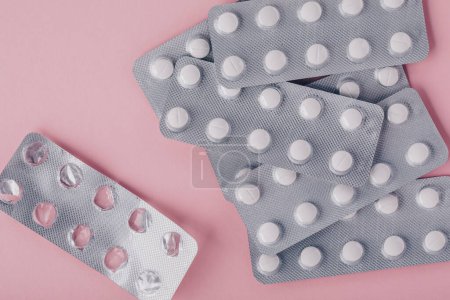 Photo for Pills in blister pack on pink background, top view with copy space. - Royalty Free Image