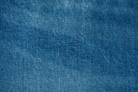 Photo for Jeans. Close-up of blue denim jeans fabric texture background. Ripped jeans - Royalty Free Image