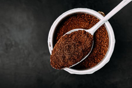 Photo for Ground coffee. Coffee moka pot make, top view with copy space on dark background - Royalty Free Image