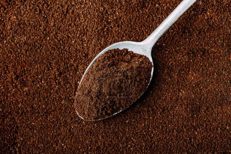 Photo for Ground coffee background. Ground Coffee with spoon close-up, top view - Royalty Free Image