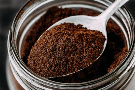 Photo for Ground coffee. Ground Coffee in jar, top view close-up on dark background - Royalty Free Image