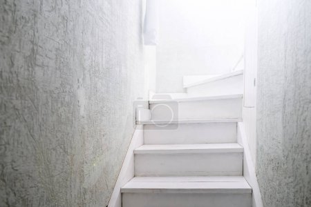 Photo for Light at the end of a white wooden staircase. - Royalty Free Image