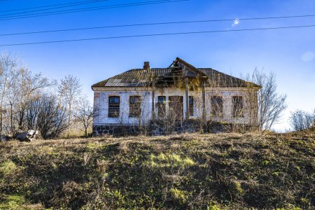 Photo for An old, abandoned brick house on a hill. - Royalty Free Image