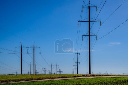 Photo for Electric poles, high-voltage towers, field. - Royalty Free Image