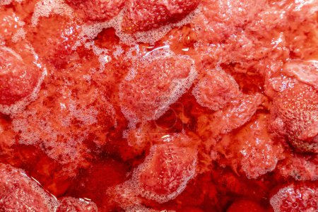 Red Strawberry jam background with gurgles and bubbles