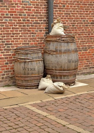 Foto de Viejos barriles de trigo y vino junto a una vieja pared de ladrillo - Imagen libre de derechos