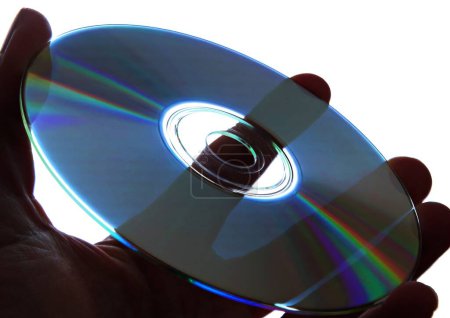 Photo for Holding a compact disc in hand with light background - Royalty Free Image