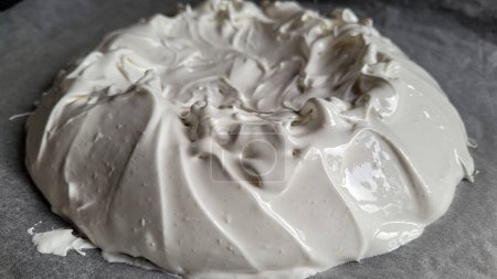The process of manufacturing Pavlova dessert on Baking Sheets. Perfect shine Peaks for White Sweet Cookies. Perfect meringue. Glutenfrei