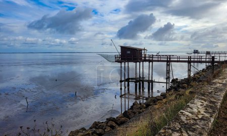 Traditional old wooden fishing huts on stilts in the Atlantic Ocean, Gironde estuary, near Talais, France