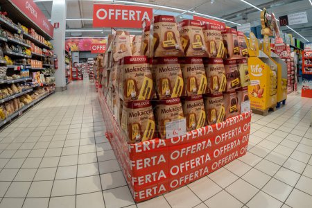 Photo for Bra, Cuneo, Italy - November 30, 2022: packs of Balocco brand pandoro filled with Segafredo brand mokaccino cream displayed in the offer pallet in an Italian supermarket. Tex: Offerta (offer) - Royalty Free Image