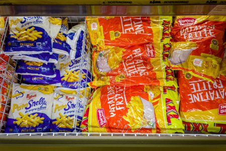 Photo for Italy - January 12, 2023: Packs of frozen pre-cooked french fries in refrigerated counter for sale in Italian supermarket - Royalty Free Image