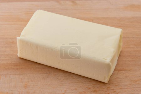 Photo for Block of butter on wooden cutting board - Royalty Free Image