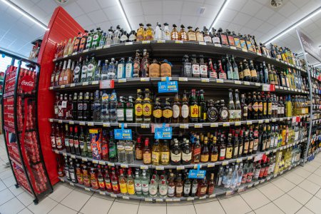 Photo for Italy - September 9, 2023: bottles of liquor, whiskey, rum and other alcoholic beverages for sale on Italian supermarket shelf, fish eye vision - Royalty Free Image