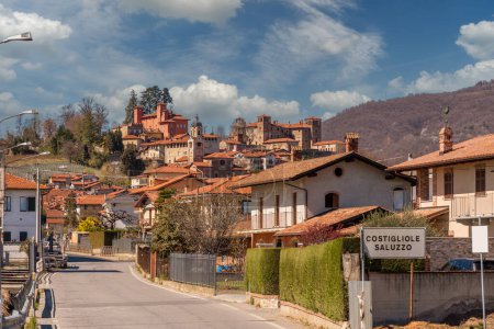 Photo for Costigliole Saluzzo, Cuneo, Italy - March 27, 2023: A landscape view of the historical village of Costigliole Saluzzo with the Red Castle and the Reynaudi Castle on the hill - Royalty Free Image