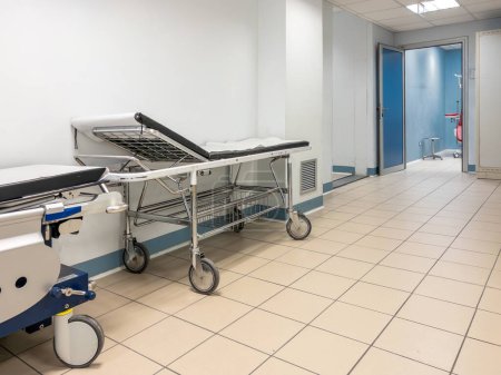 Empty stretcher bed in emergency department hallway