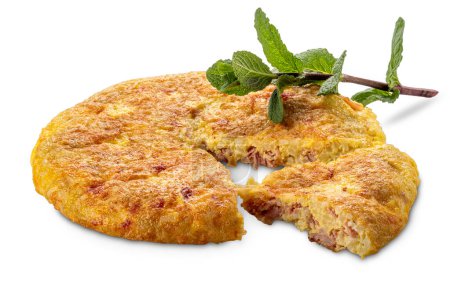 Rice omelet with ham and cheese with cut slice and sprig of mint isolated on white with clipping path included