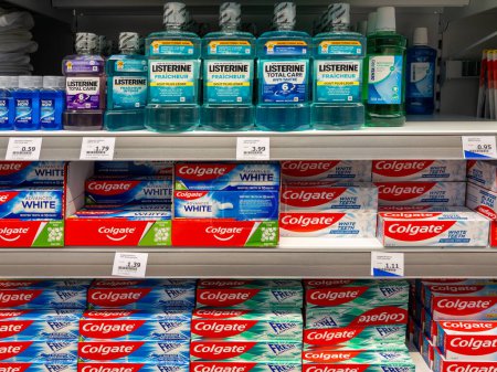Photo for Italy - March 20, 2024: Listerine mouthwash bottles and colgate toothpaste packs displayed on shelves for sale in Italian supermarket - Royalty Free Image