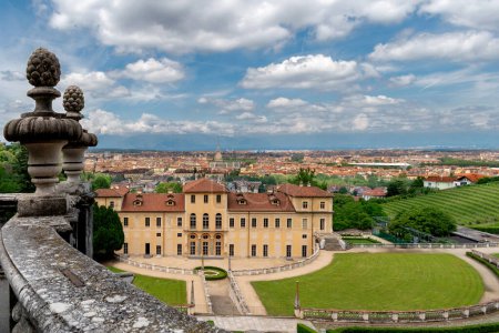 Cityscape of Turin, Italy, view from the Villa della Regina residence of the Savoy queens with historic vineyard and the view of the Mole Antonelliana in the background with blue sky with clouds 