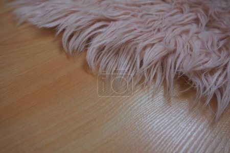 Photo for Long pile rug in pink on a beige laminate floor. Feminine interior for a room or bedroom of a girl or woman. Interior design in pink tones. Flooring is laminate. The role of dust mites in allergies - Royalty Free Image