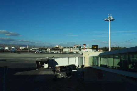 Téléchargez les photos : Ankara, Turkey, Esenboga Havalimani airport, 01.19. 2023 View from the window of the passenger terminal on the runway area. Airplane bridge. Tower with antenna. Airport building, boarding gate. Clouds - en image libre de droit