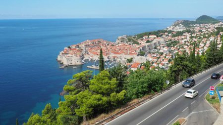 Photo for Road traffic near Dubrovnik old town in Croatia. Dubrovnik Ragusa is a city in Croatia, the administrative center of the Dubrovnik-Neretva County. Top view from the observation deck on the rock - Royalty Free Image