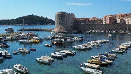 Photo for Dubrovnik, Croatia, 08.14. 2022 City port summer tourist attraction. Tourists walk, get into boats and ships and go on boat trips. Adriatic Sea. Travel and recreation. Private boats of local citizens - Royalty Free Image