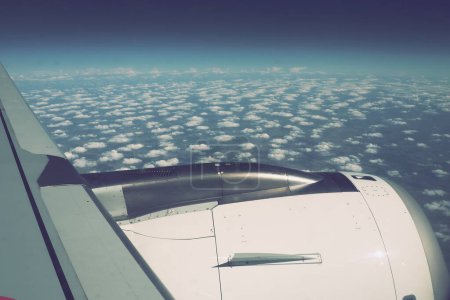 Photo for Aircraft engine and wing on the border of atmosphere and space. The edge of the troposphere. Horizon over the Earth. Flights, travel and tourism. View from a window or porthole. Clouds and blue sky - Royalty Free Image