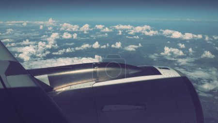 Photo for Aircraft engine, wing on the edge of the troposphere. Horizon over the Earth. War plane. Space Forces. War and peace. Clouds blue sky. Flight over the mountainous terrain, movement above the clouds - Royalty Free Image