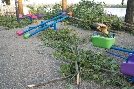 Photo for Aftermath of the hurricane July 19, 2023 beach Sremska Mitrovica, Serbia. Broken trees, mess on the streets. Broken branches, bent trunk. Playground. State of emergency after a catastrophic storm - Royalty Free Image