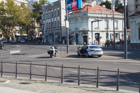 Photo for Belgrade, Serbia, 9.9.2023 Pride protest march Slavia Square. The Pride march. Police cordon in the Belgrade center. A police car and a motorcycle blocked the roadway. Turn onto Deligradskaya street - Royalty Free Image