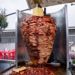 Mexican al pastor style meat, grilled, at a taco stand on the street.