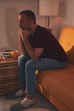 Photo for Bored man with lethargy and apathy sitting at home alone. - Royalty Free Image