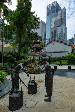 Foto de Singapore City, Singapur - Diciembre 2022: Vistas del parque Telok Ayer Green con estatuas que representan a los primeros colonos de la zona el 6 de diciembre de 2022 en Singapore City, Singapur. - Imagen libre de derechos