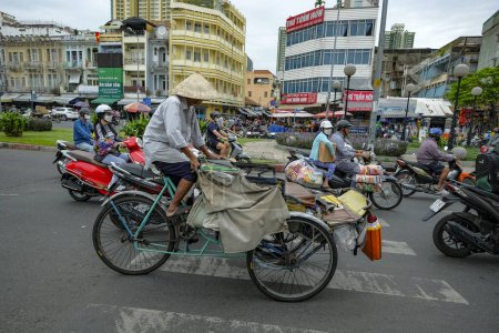 Photo for Ho Chi Minh City, Vietnam - January 6, 2023: A man with a tricycle on a street in Ho Chi Minh City, Vietnam. - Royalty Free Image