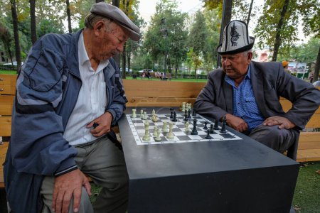 Photo for Bishkek, Kyrgyzstan - September 4, 2023: People playing chess in a park in Bishkek, Kyrgyzstan. - Royalty Free Image