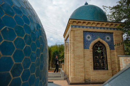 Photo for Rishton, Uzbekistan - October 22, 2023: A man sweeping at the Mausoleum of Burhan al-Din al-Marghinani at Rishton in the Fergana Valley, Uzbekistan. - Royalty Free Image