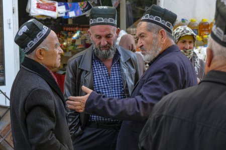 Photo for Istaravshan, Tajikistan - November 26, 2023: Men chatting at the Istaravshan Central Market, Tajikistan. - Royalty Free Image