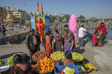 Photo for Nashik, India - January 25, 2024: Women selling fruit at the Ganga Ghat in Nashik, India. - Royalty Free Image