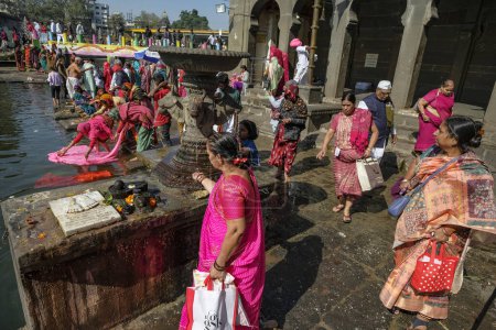 Photo for Nashik, India - January 25, 2024: Women making offerings at the Ganga Ghat in Nashik, India. - Royalty Free Image