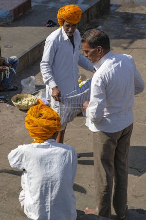 Photo for Nashik, India - January 25, 2024: Turbaned men visiting the Ganga Ghat in Nashik, India. - Royalty Free Image