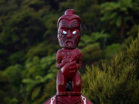 Photo for Traditional ancient red wooden Maori sculpture figure in Abel Tasman National Park Nelson Tasman South Island of New Zealand - Royalty Free Image