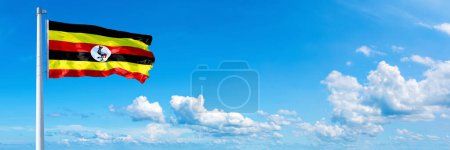 Photo for Uganda Flag - state of USA, flag waving on a blue sky in beautiful clouds - Horizontal banner - Royalty Free Image