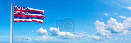 Téléchargez les photos : Hawaii Flag - state of USA, flag waving on a blue sky in beautiful clouds - Horizontal banner - en image libre de droit