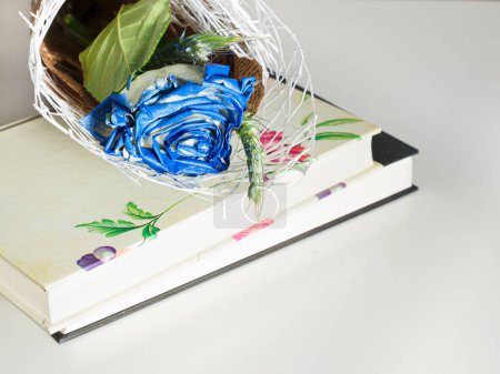 Close-up of a white and blue rose on a book for St. George's Day. Valentine's Day in Catalonia, Spain.