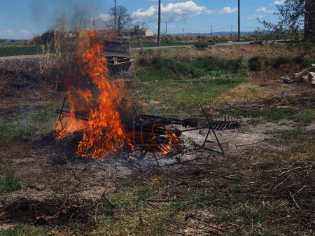 Burning fire to roast "Calsots", a young Catalan onion, in the middle of the countryside. "Calsotada", typical Catalan food.