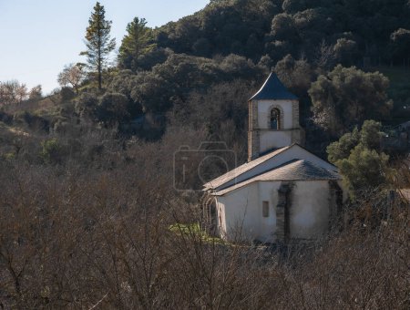 Nuestra Seora de la Asuncin, parish church of San Juan de Paluezas, located at the top of the town and surrounded by large trees allowing a glimpse between the branches of deciduous trees