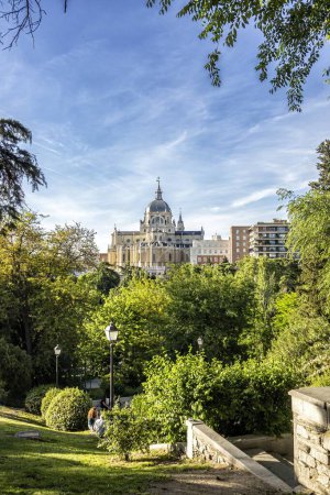Almudena Cathedral of Madrid, neoclassical style seen on a spring day among the trees of the Vistillas Garden