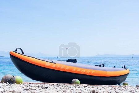 Foto de Rubber boat on the seashore with the inscription "WATER SPORT". - Imagen libre de derechos