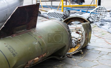 Photo for Remains of missile units of the operational-tactical missile system Tochka-U, 9M79-1. The air defense system shot down a missile, part of it fell near the house. Soviet tactical bomb on the street - Royalty Free Image